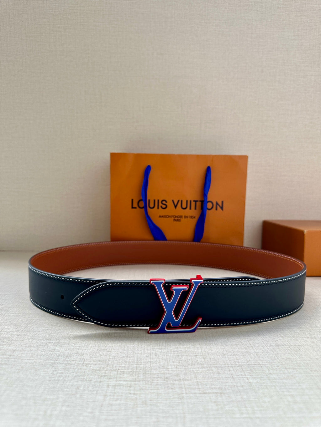 Dark blue leather belt with LV monogram buckle and stitched edge, flat style