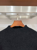 Dark long-sleeve sweater neckline and textured knit, pullover style