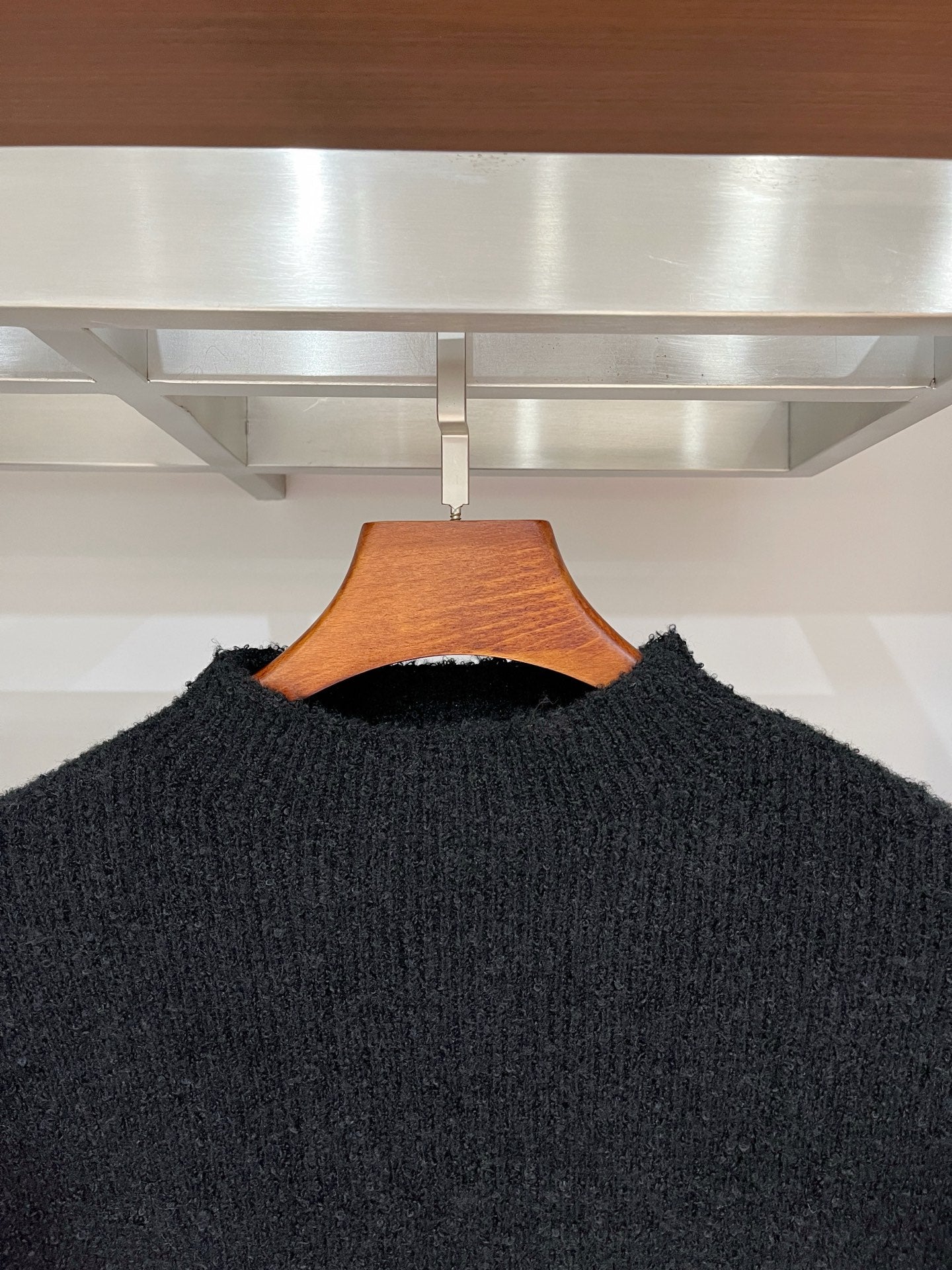 Dark long-sleeve sweater neckline and textured knit, pullover style