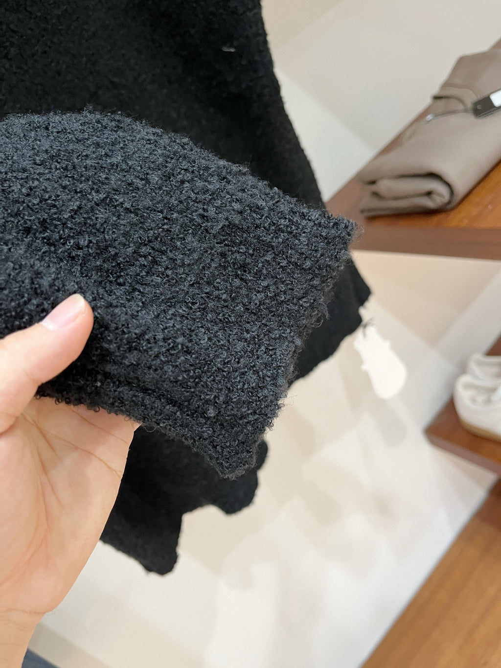 Dark sweater cuff with ribbed knit edge and fuzzy texture