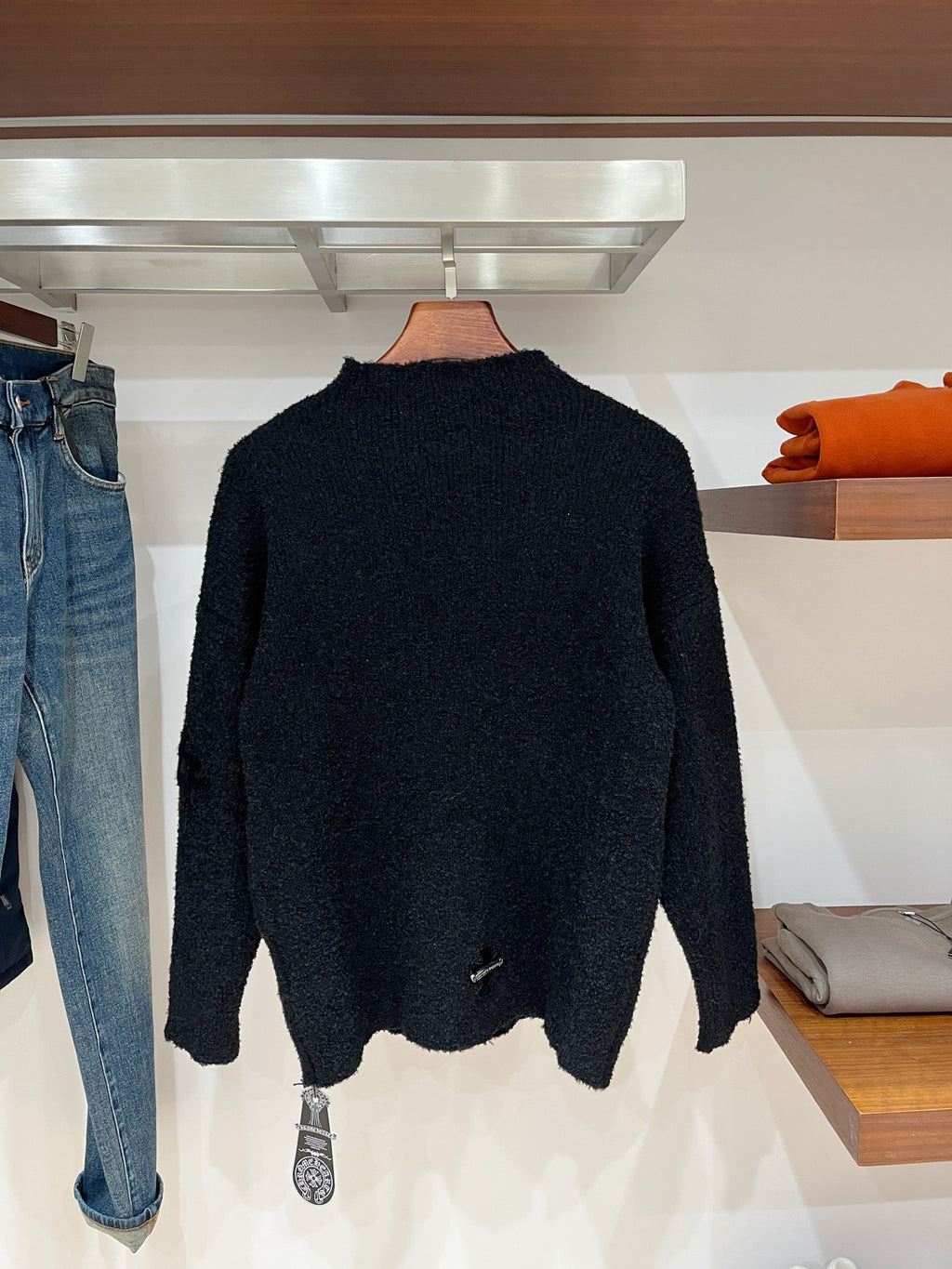 Dark textured long-sleeve sweater with high neckline, back view
