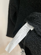 Dark sweater with inside care label and size tag