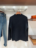 Dark textured long-sleeve sweater with high crew neckline, pullover style