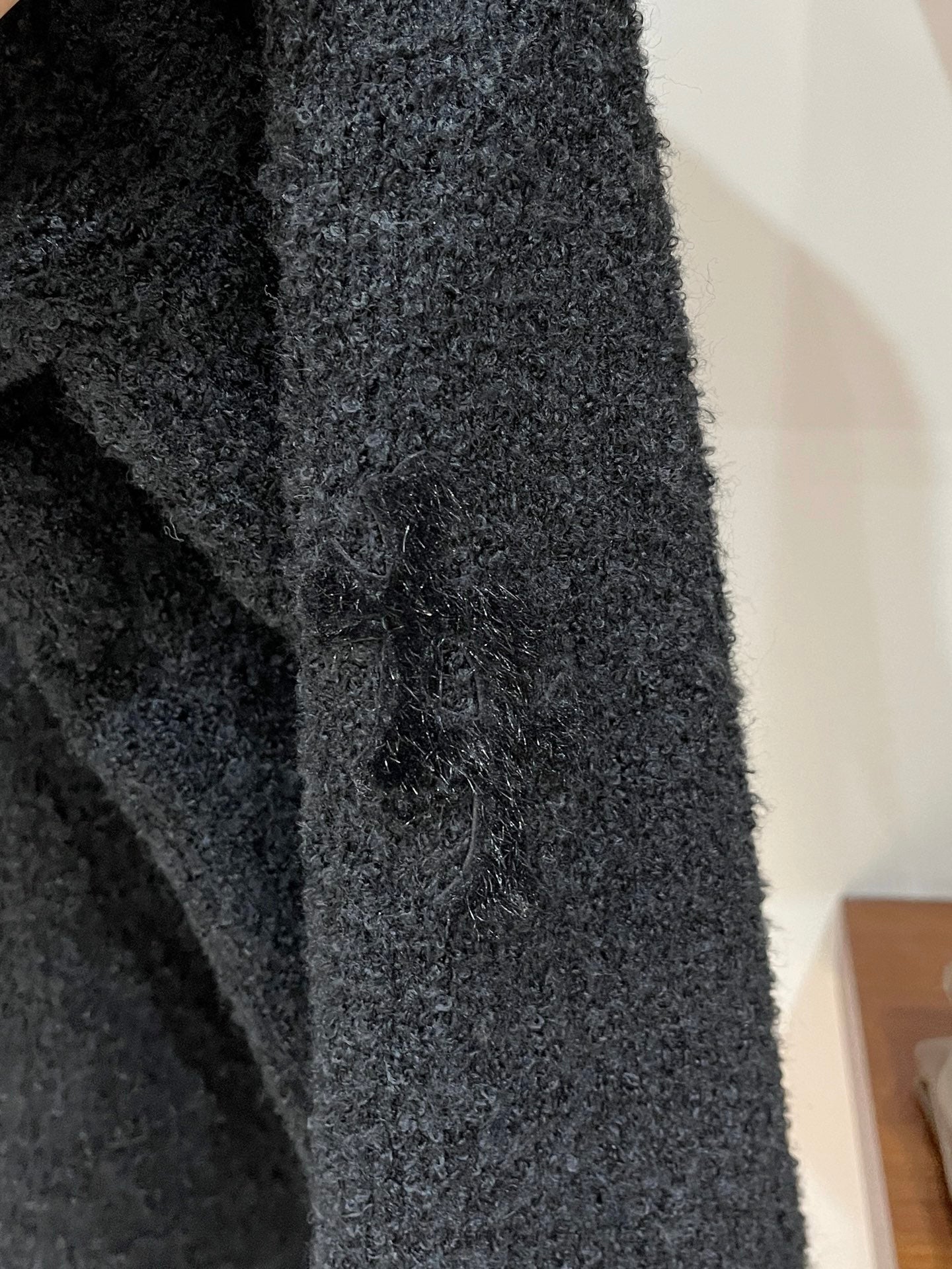 Dark textured knit sleeve cuff and side seam detail