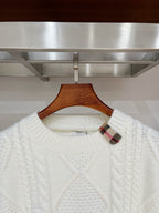 Cream cable-knit crewneck sweater with plaid inner collar detail