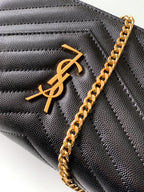 YSL black quilted leather bag close-up with gold YSL monogram and chain