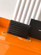 YSL black quilted flap bag with gold chain strap and YSL-style logo at center