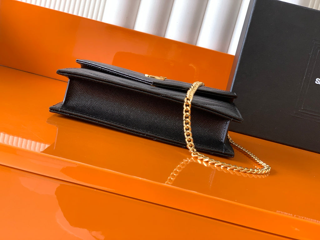 YSL black leather flap bag with gold chain shoulder strap and snap closure