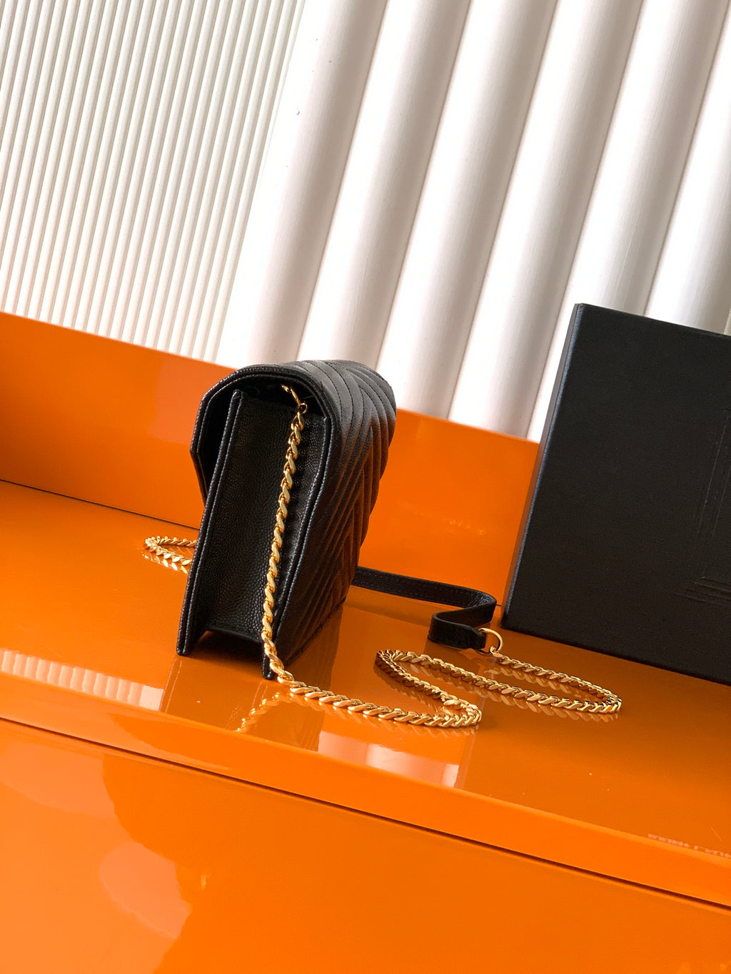 YSL black quilted flap bag with top handle, gold chain strap and clasp hardware