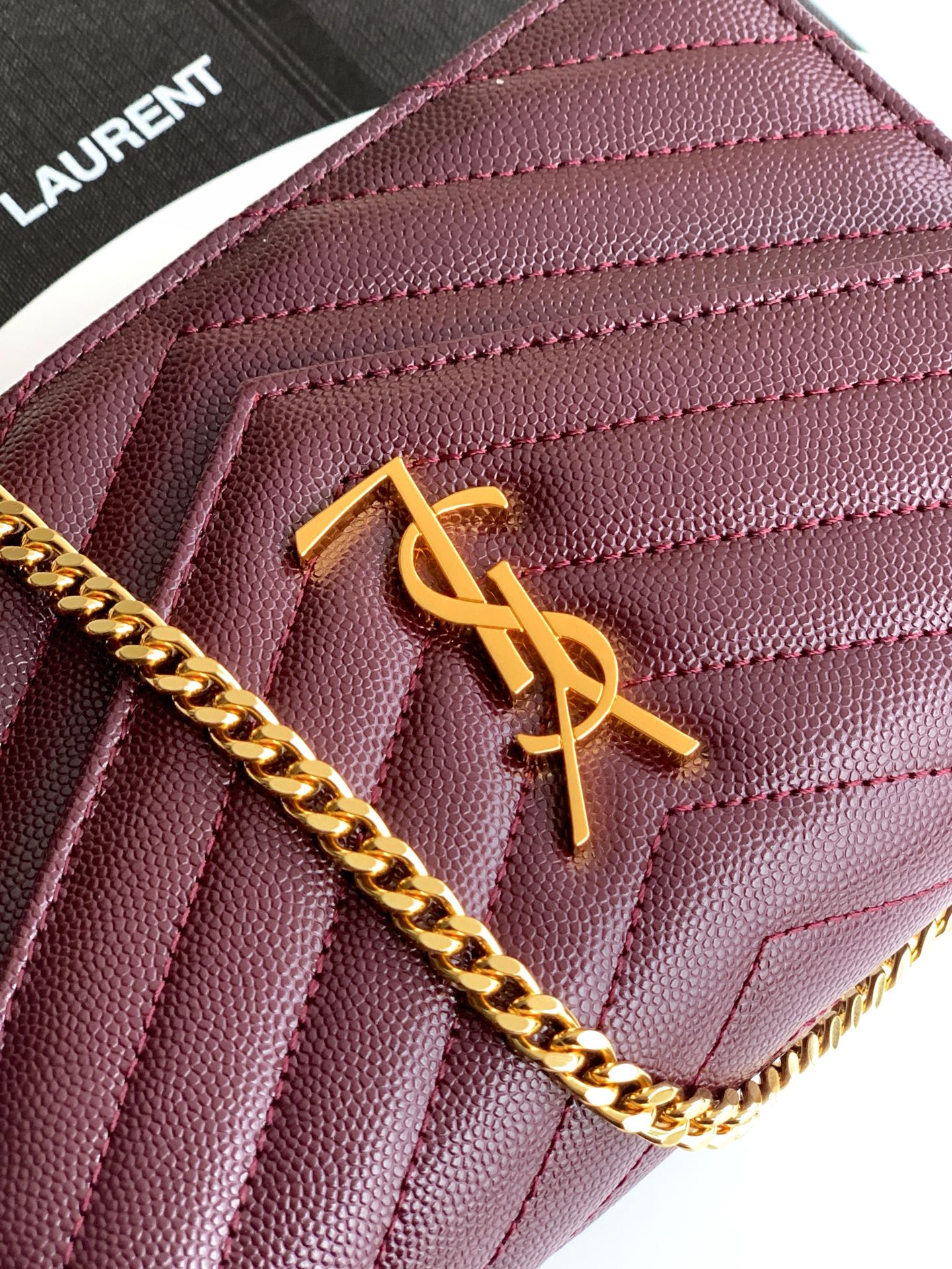 Burgundy textured leather bag with gold YSL monogram detail and chain
