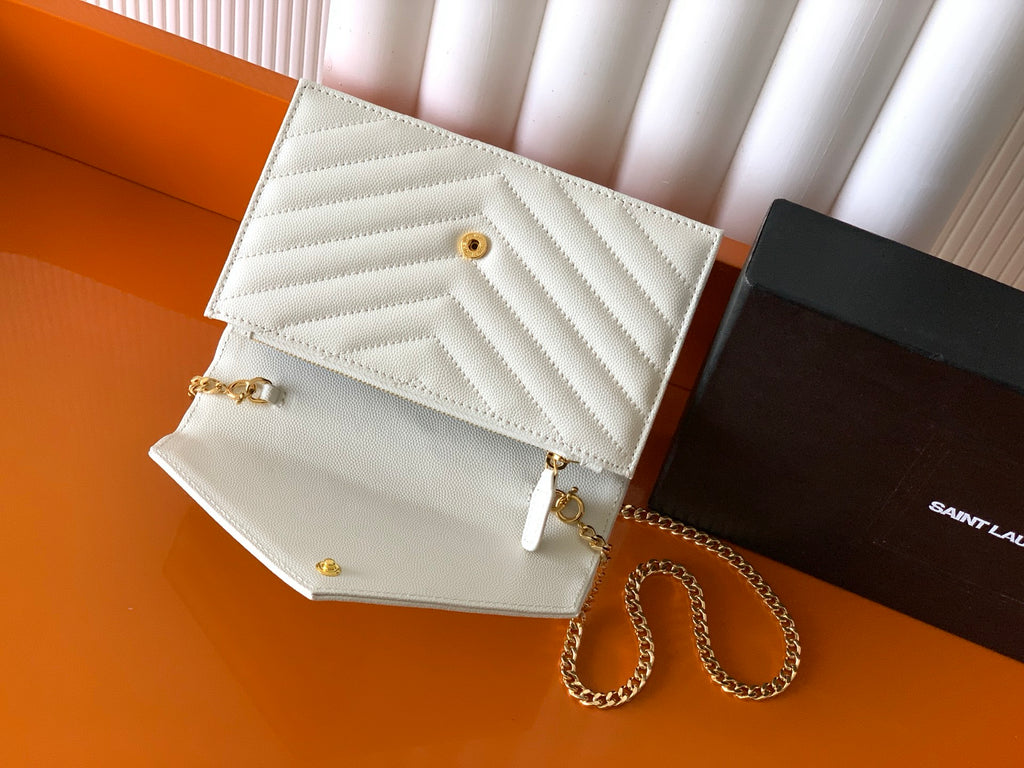 YSL white quilted flap bag with gold snap button and chain strap