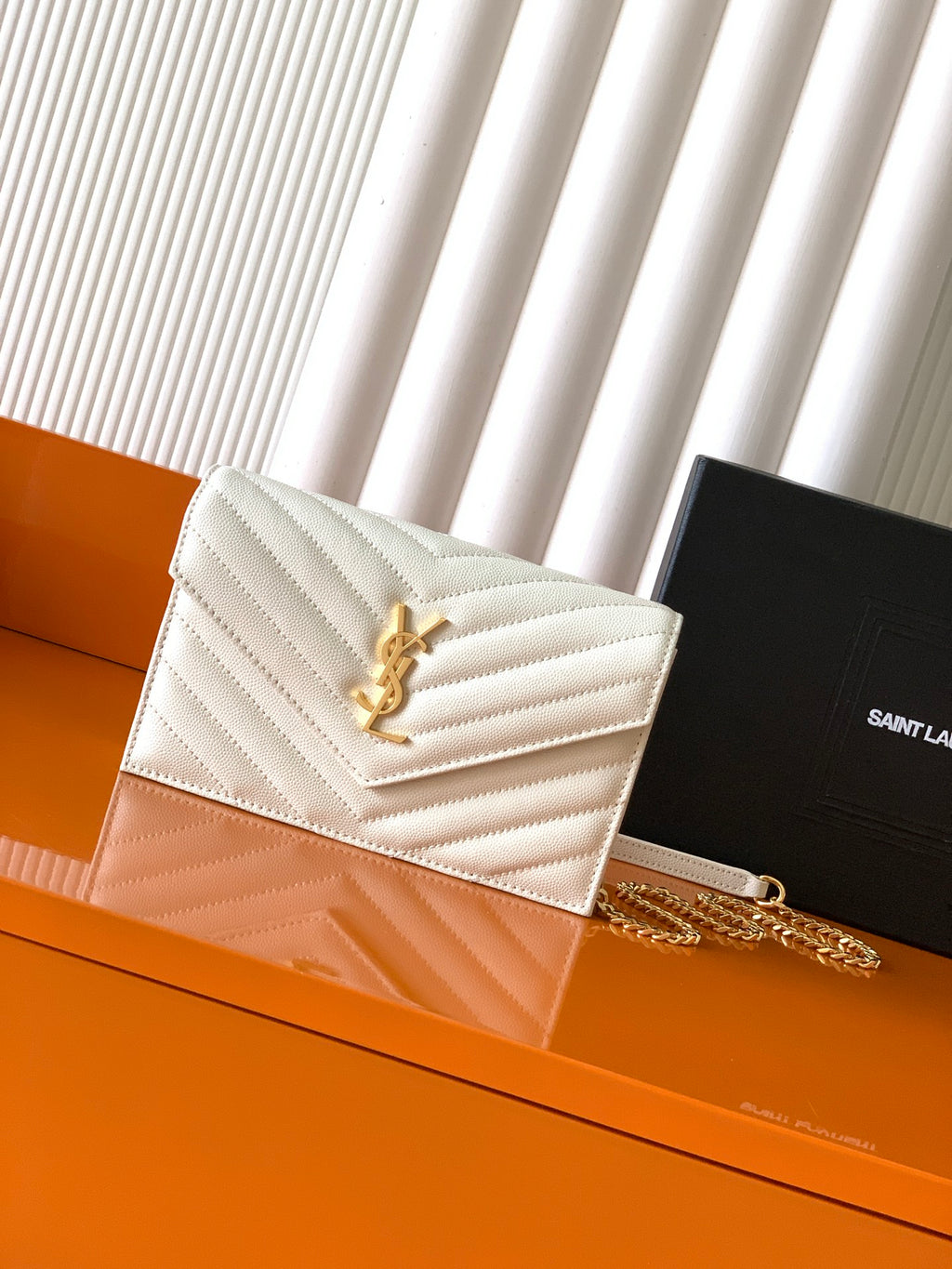YSL white quilted shoulder bag with gold logo and chain strap