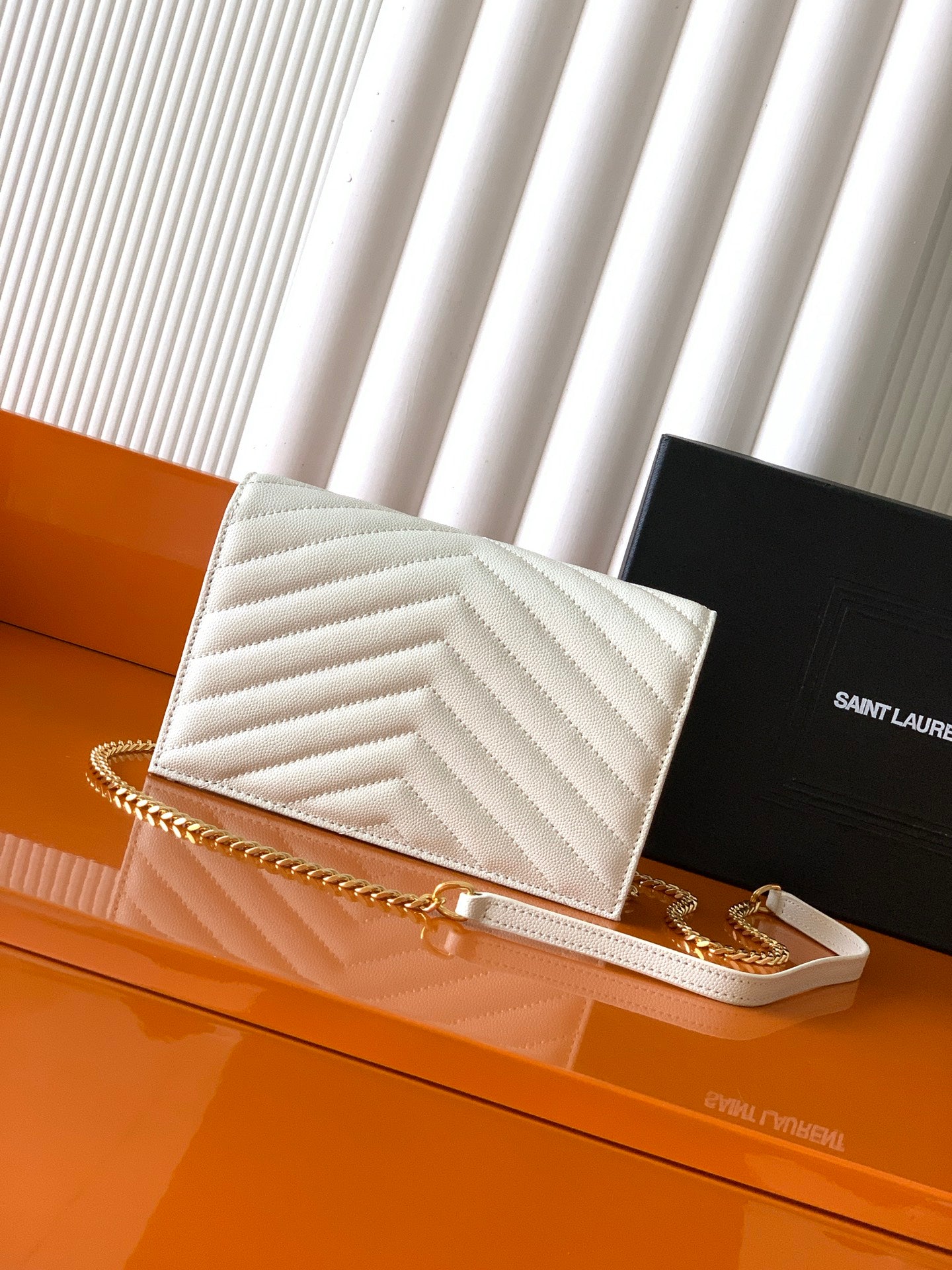 YSL white chevron quilted flap bag with gold chain strap