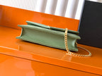 Green leather YSL bag with flap and gold chain strap on open top edge
