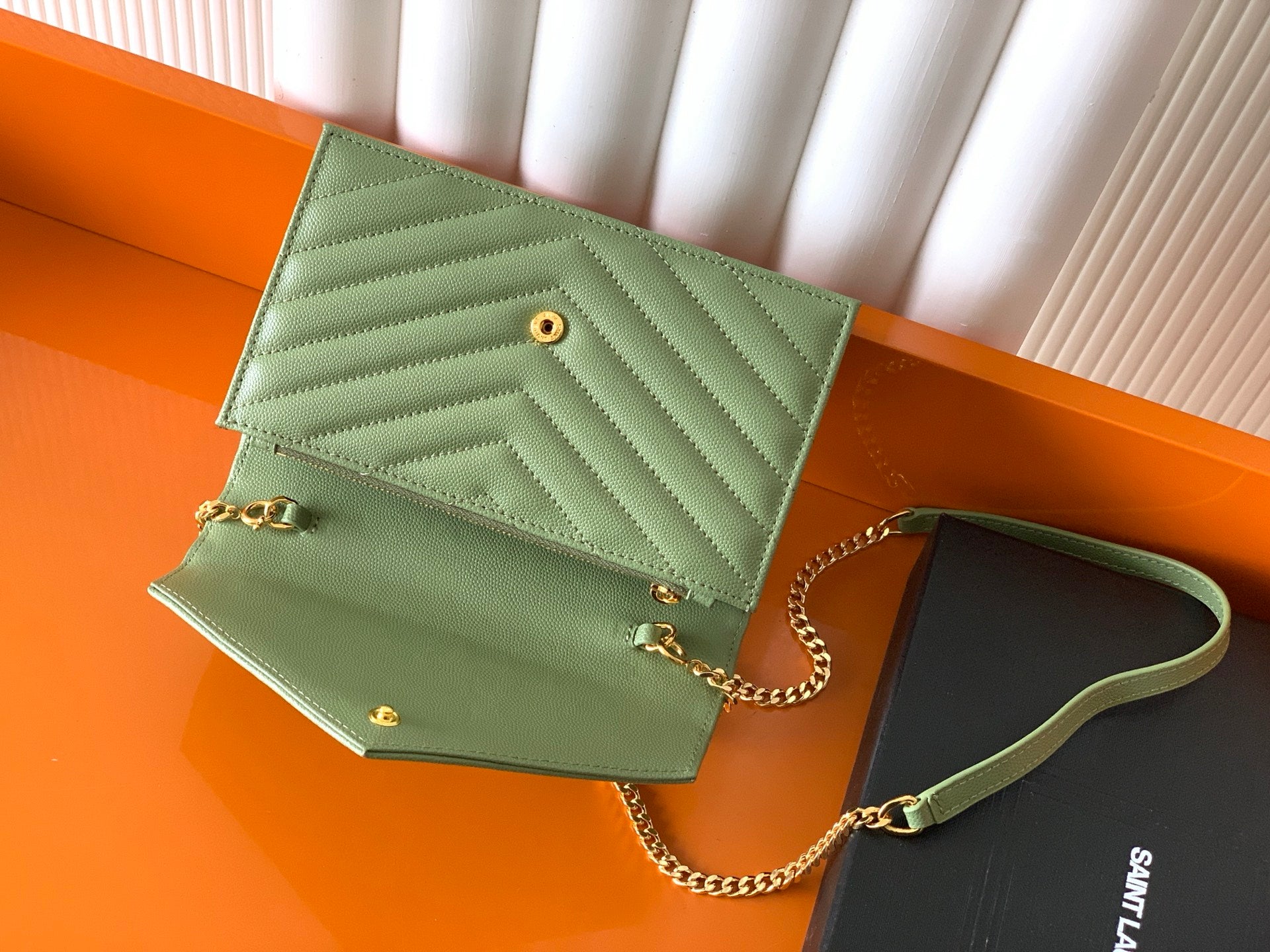 Green YSL shoulder bag with quilted flap, gold hardware, and chain strap