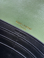 Close-up of green and black YSL bag panels with stitching and hardware