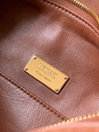 Loewe logo plaque on tan-brown leather with gold-tone metal and stitching