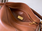 Loewe interior view of tan-brown leather bag with zip pocket and gold zipper