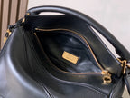 Loewe black leather bag interior with zip pocket and gold zipper hardware, logo tag visible