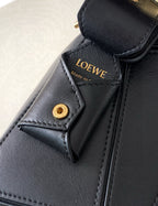 Black leather bag detail with gold button and Loewe logo label