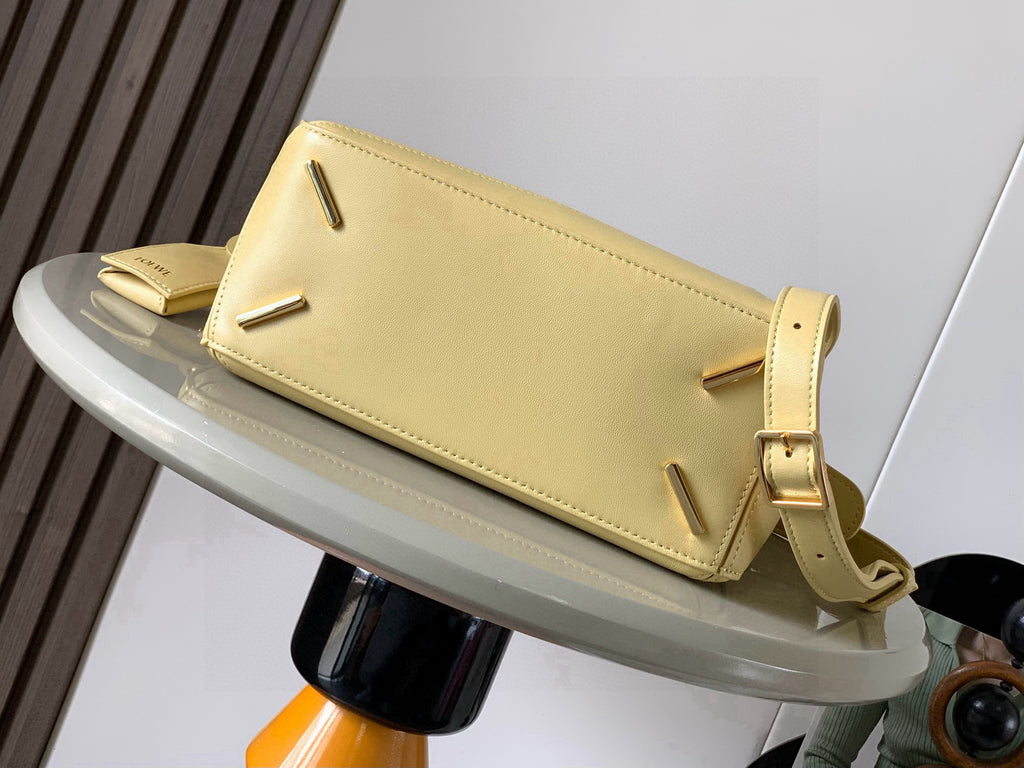 Loewe light yellow leather baguette bag with front flap and gold stud details
