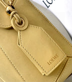 Loewe light yellow leather bag close-up with O-ring strap attachment and side stitching