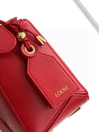 Red leather bag strap panel with Loewe logo patch and gold ring hardware