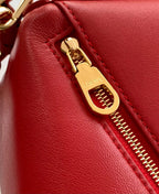 Red leather bag zipper pull with Loewe metal badge, gold-tone hardware