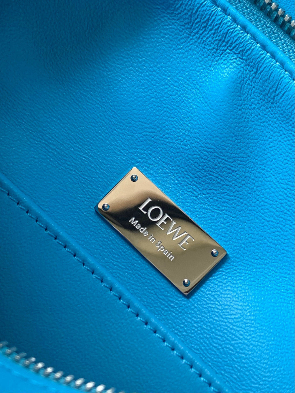 Blue leather bag with Loewe metal logo plate and contrast stitching