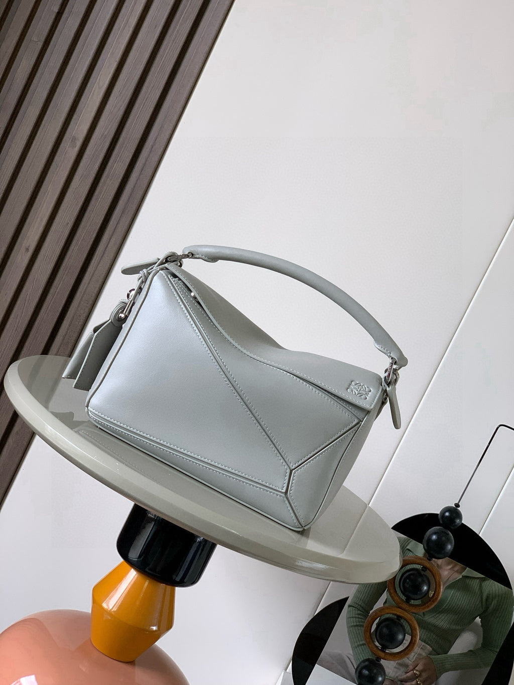 Loewe light-blue handbag with top handle, flap front, and silver-tone hardware.