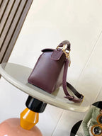 Loewe maroon leather shoulder bag with front flap, curved strap, and gold hardware