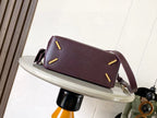 Loewe leather crossbody bag in dark burgundy with decorative corner studs and strap