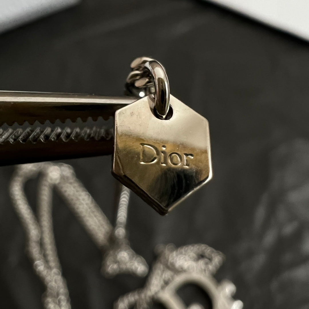 Gold-tone Dior engraved charm tag on ring, with chain connector