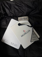 Moncler logo patch and hanging tags on puffer jacket