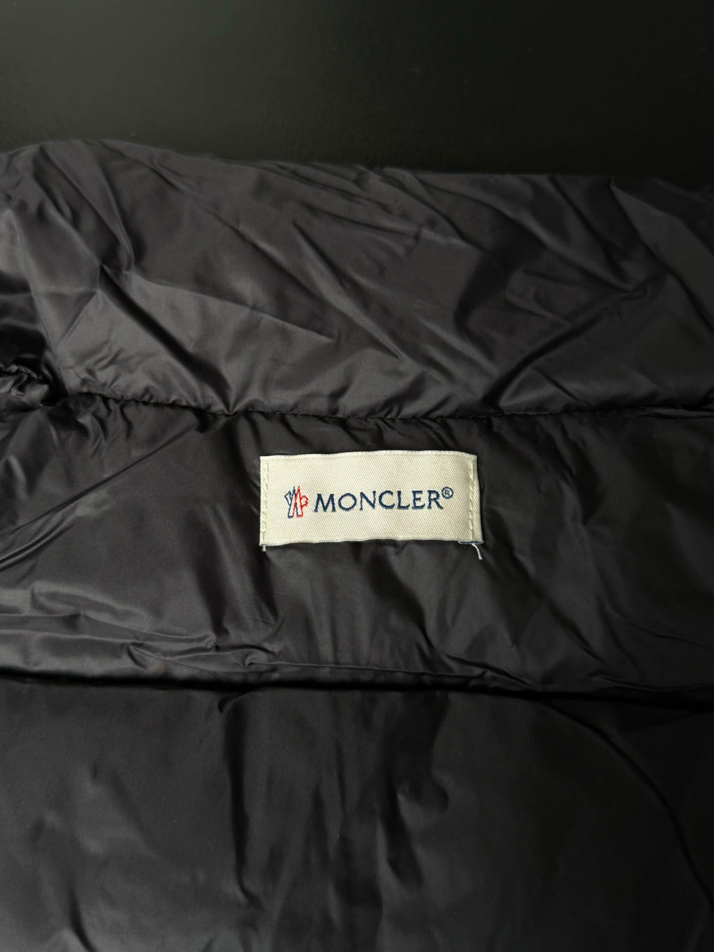 Moncler logo patch on puffer jacket lining