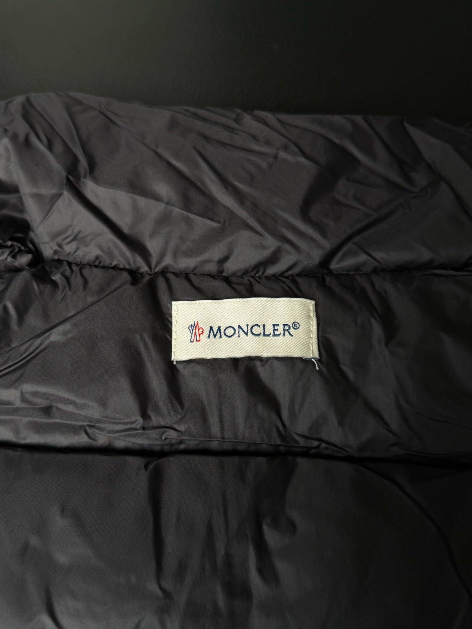 Moncler logo patch on puffer jacket lining