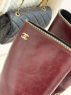Burgundy boot upper with Chanel logo and gold chain-trim edging