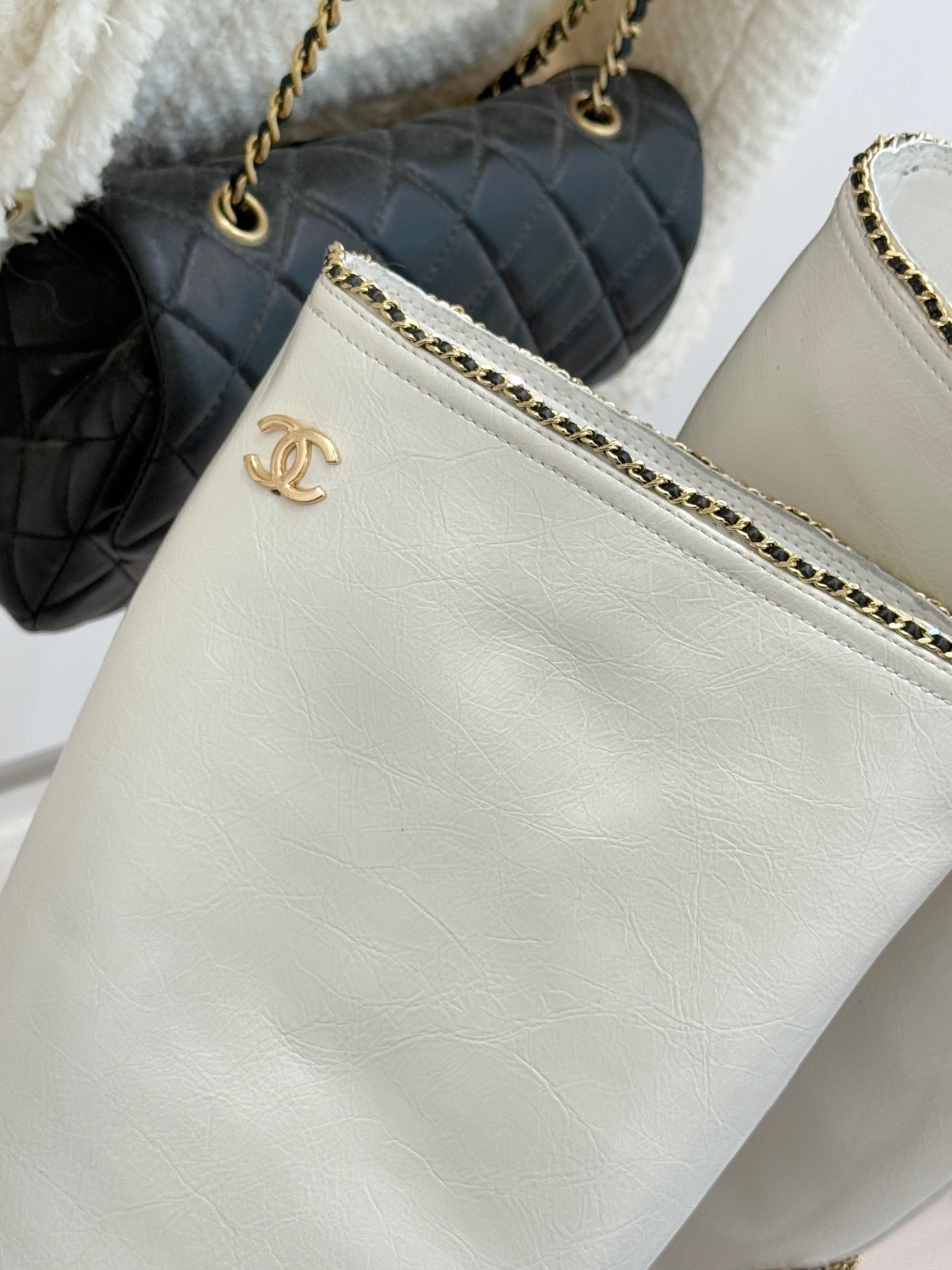 White leather clutch purse with gold chain strap and Chanel emblem