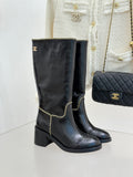 Black knee-high leather boots with gold chain trim and block heel