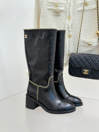 Black knee-high leather boots with gold chain trim and block heel