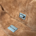 Tan suede handbag showing Balenciaga logo label and rectangular care tag