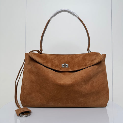 Tan suede top-handle handbag with curved flap and metal buckle clasp