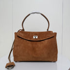Balenciaga suede top-handle bag with front flap closure and metal lock clasp, tan