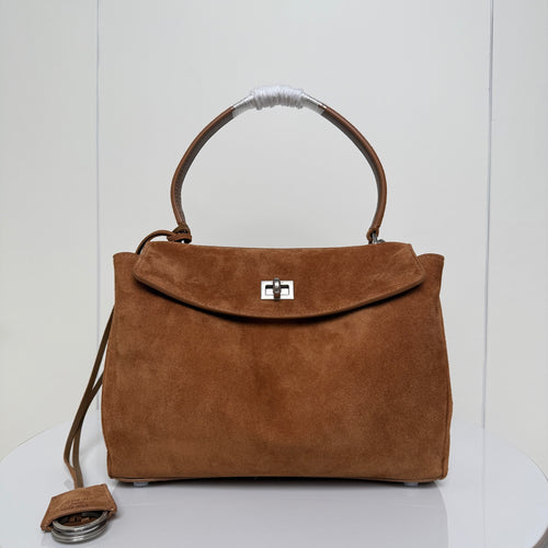 Balenciaga suede top-handle bag with front flap closure and metal lock clasp, tan