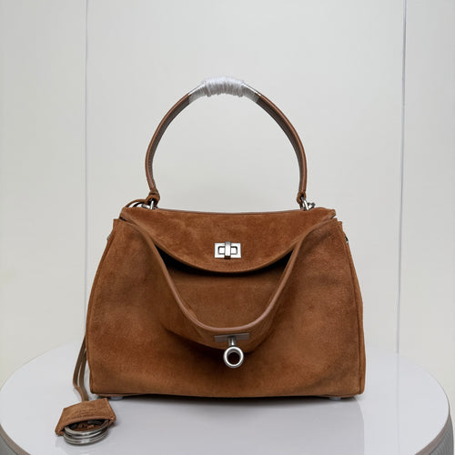 Balenciaga suede top-handle bag with front flap and metal lock clasp, tan brown