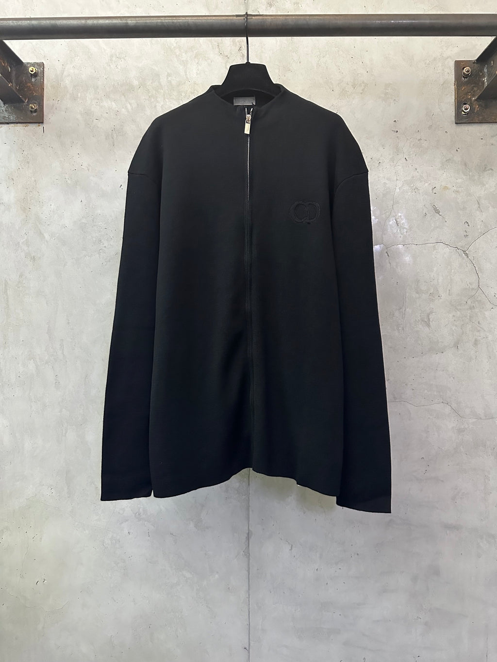 Black zip-up jacket with long sleeves and full front zipper