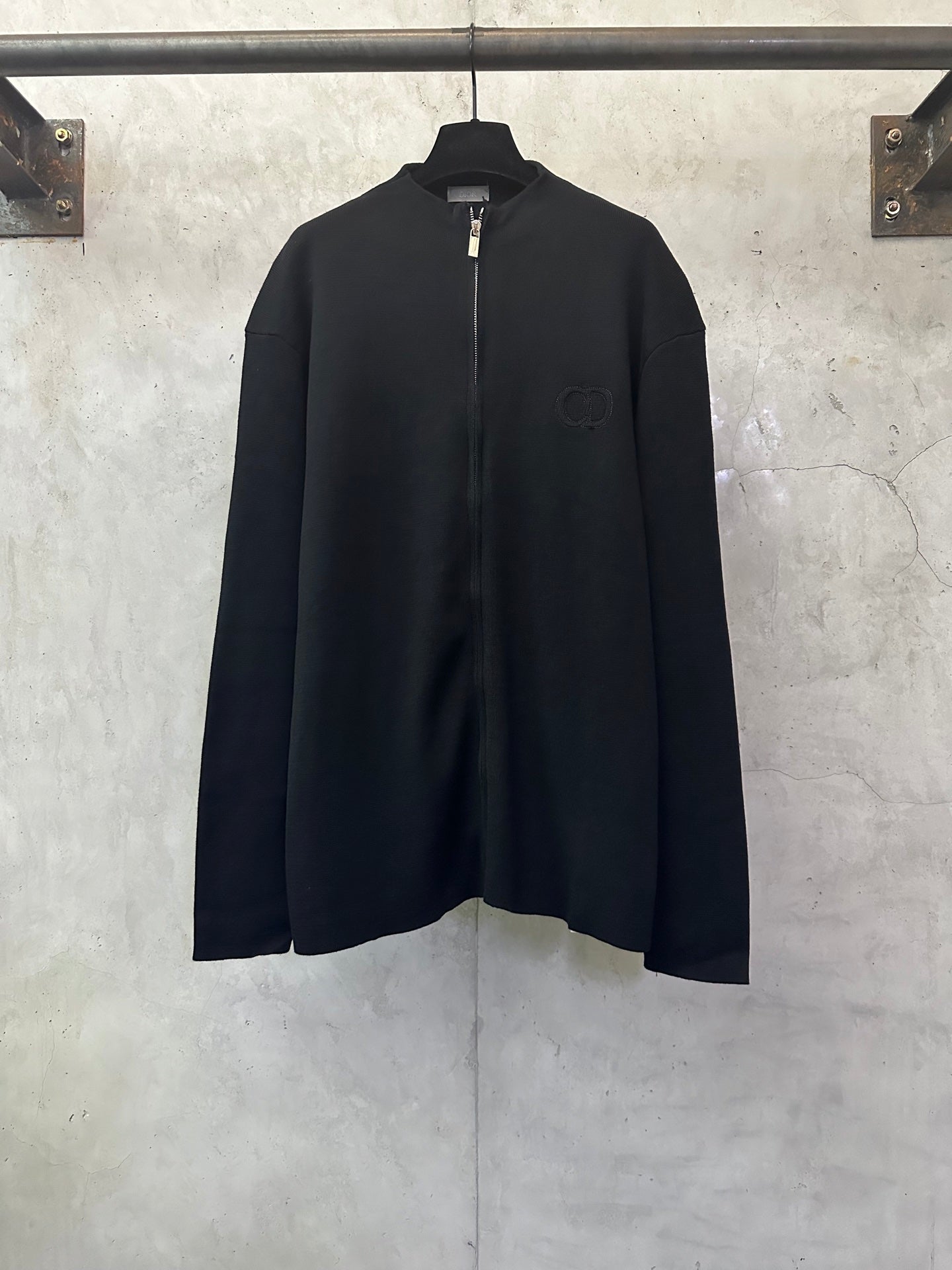 Black zip-up jacket with long sleeves and full front zipper
