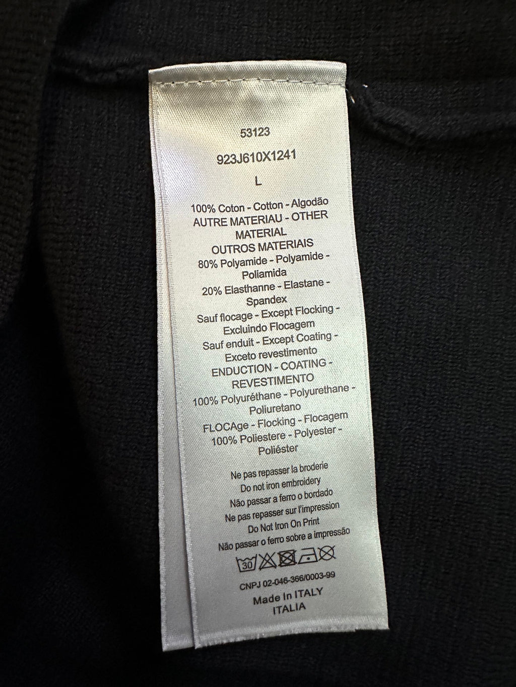 Interior fabric care label on black zip-up jacket
