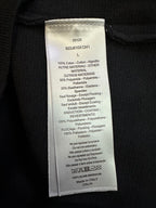 Interior fabric care label on black zip-up jacket