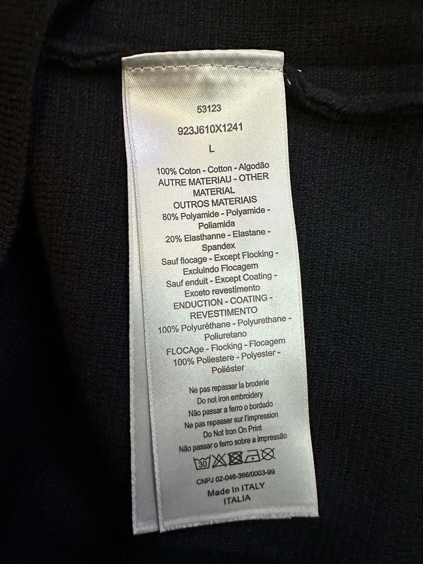 Interior fabric care label on black zip-up jacket